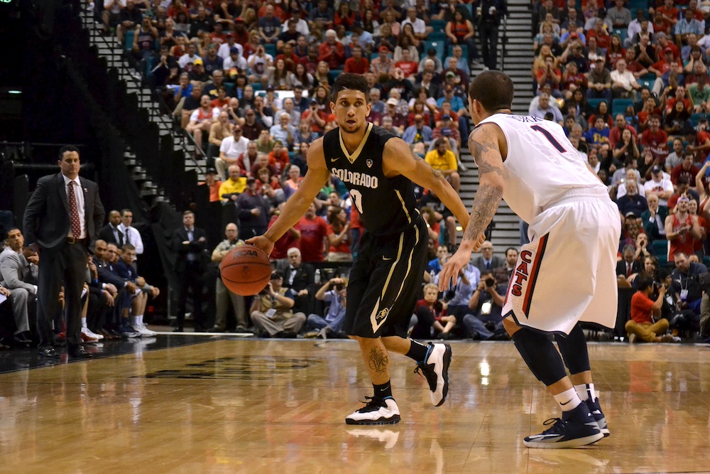 Guard Askia Booker (0) dribbles the ball around the perimeter during the second half against Arizona Friday, March 14, 2014 at the MGM Grand Garden Arena in Las Vegas, Nev. (Nate Bruzdzinski/CU Independent)