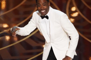 Chris Rock hosting the 88th Academy Award clad in a white tuxedo. (Photo courtesy of Getty Images)