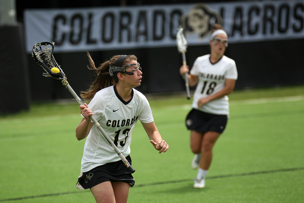 Colorado freshman attacker/midfielder Katie Macleay (13) brings the ball around the net during a women's lacrosse game between Colorado and California, Sunday, April 20, 2014, at Kittredge Field in Boulder, Colo. The Buffs lost 6-7. (Kai Casey/CU Independent)