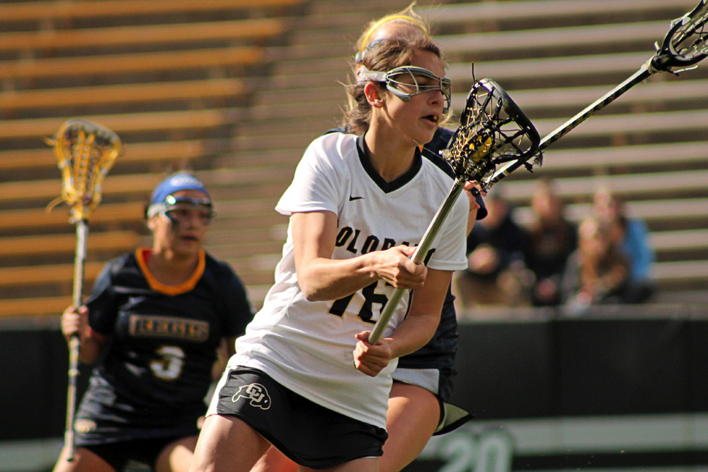 Colorado freshman Johnna Fusco heads down the field with the ball during the University of Colorado's 13-10 win over Regis University, Feb. 22, 2014 at Folsom Field in Boulder, Colo. . (Maddie Shumway/CU Independent)