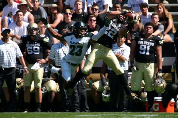 Colorado junior wide receiver Nelson Spruce (22) grabs a 71-yard touchdown catch over Hawaii senior defensive back Dee Maggitt (23) during an NCAA football game between the Colorado Buffaloes and the Hawaii Rainbow Warriors, Saturday, Sept. 20, 2014, at Folsom Field in Boulder, Colo. The Buffs won 21-12, getting their first home win of the season. (Kai Casey/CU Independent)