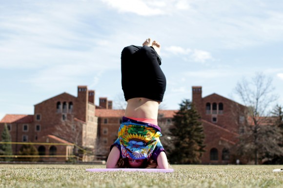 Emily Kathrine, a sophomore at CU, practices yoga on Farrand Field. "Yoga is a good way to get every muscle in your body working, and to find balance within yourself," Kathrine said. (Calyx Ward/CU Independent)