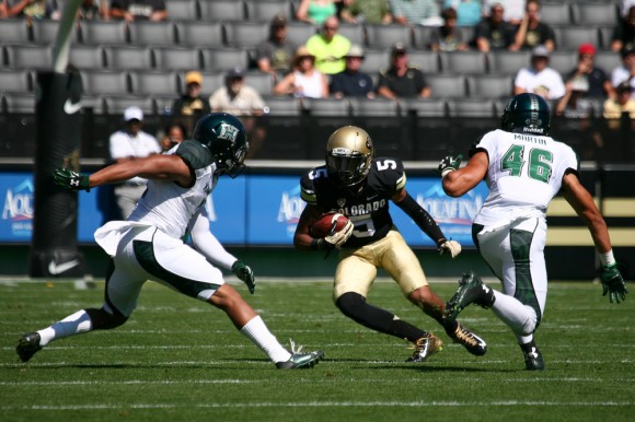 Colorado freshman wide receiver Shay Fields (5) looks to slip between Hawaii junior defensive back Ne'Quan Phillips (1) and Hawaii senior defensive back Michael Martin (46) during an NCAA football game between the Colorado Buffaloes and the Hawaii Rainbow Warriors, Saturday, Sept. 20, 2014, at Folsom Field in Boulder, Colo. The Buffs won 21-12, getting their first home win of the season. (Kai Casey/CU Independent)
