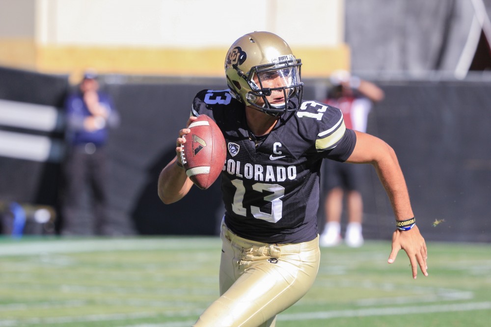 Quarterback Sefo Liufau scrambles while looking for an open receiver at Folsom Field on Oct. 25, 2014. (Nigel Amstock/CU Independent File)