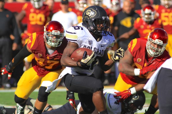 Colorado running back Tony Jones (26) looks for an open seam among Trojan defenders during the first half of play at the Los Angeles Memorial Coliseum on Saturday. (Nigel Amstock/CU Independent)