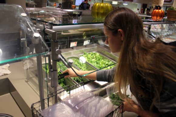 Lauren Borchers, psychology junior, opts for spinach and kale in her salad the at Alferd Packer Restaurant & Grill in the UMC. Borchers enjoys the freshness of the food at Alfred Packer Grill and said the salad bar is always her favorite. (Jade Lang/CU Independent)