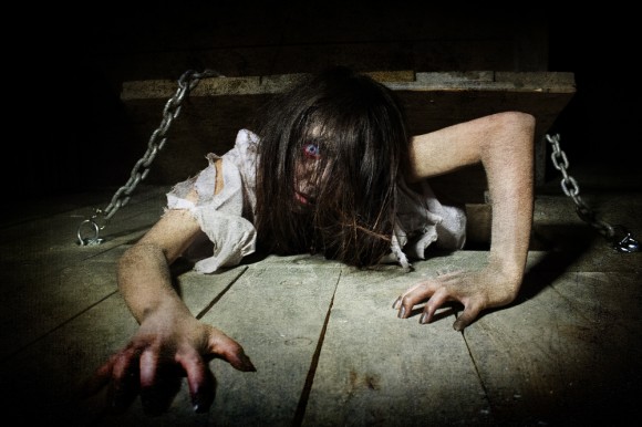 A "possessed girl" crawls across the wooden floor at the 13th Floor Haunted House in Denver, Colo. The haunted house, located at 4120 Brighton Blvd., (Photo Courtesy of Kaitlyn Jaffke/13th Floor Haunted House)