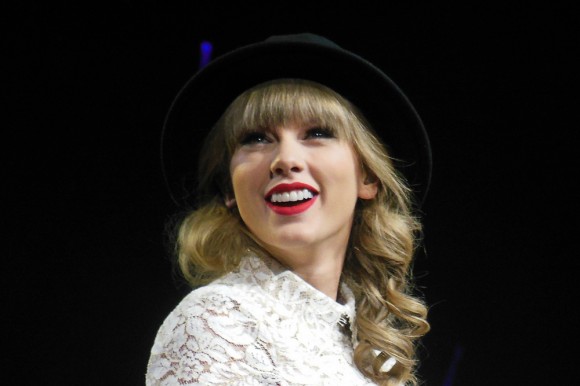 Taylor Swift takes a break to smile during a stop on her Red Tour, March 25, 2013. (Photo Courtesy of jazills/Wikimedia Commons)