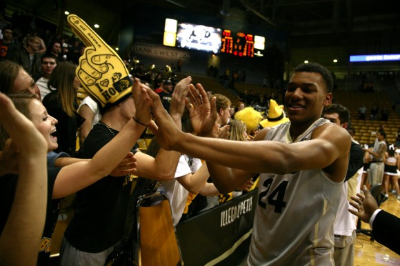 George King (24) high-fives fans after defeating Wyoming during the 2013-14 season his freshman year. During today's media day,  coach Tad Boyle announced that King will redshirt this 2014-2015 season. (Kai Casey/CU Independent)