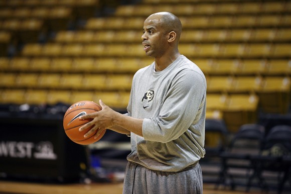Jean Prioleau, Colorado associate head coach, helps his team run through drills during practice in the Coors Events Center, Friday, Feb. 21, 2014, in Boulder, Colo.  (Kai Casey/CU Independent)