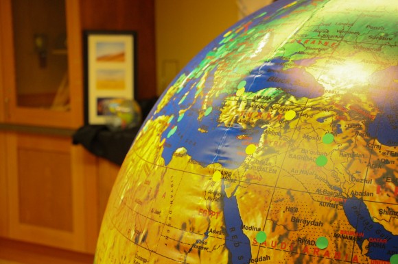 A five-foot diameter globe sits at the front of Wednesday's reception for International Education Week. Attendees were encourages to place sticker over locations they've been or want to go through the Office of International Education. (Gray Bender/CU Independent)