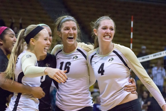 Gwen Herring (21), Cierra Simpson (10), Taylor Simpson (16), and Anna Pfefferle (4), celebrate together after upsetting No. 2 Washington last Thursday. On Sunday, the Buffs outlasted Washington State, winning in the fifth set. (Matt Sisneros/CU Independent)