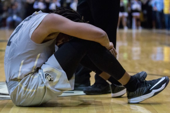 Junior forward, Xavier Johnson, puts his head between his knees after missing a last second shot to possibly tie the game up. (Matt Sisneros/CU Independent)
