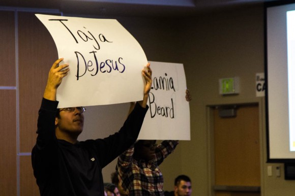 Women and Gender Studies professor, Dr. Michele Simpson, had students in the audience hold up the names of several black transgender women who have been killed so far in 2015. (Robert Hylton/CU Independent)