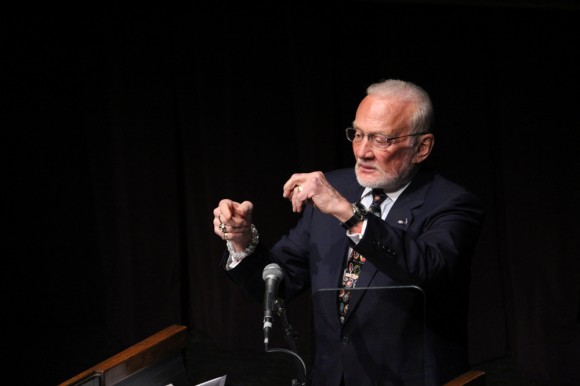 Apollo astronaut Buzz Aldrin explains his ideas for future human travel to Mars, using his hands to represent interactions between different low-earth orbit space ships. Aldrin recently released a book titles Mission to Mars that details his ideas. (Gray Bender/CU Independent)