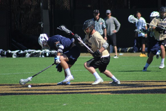 A CU Lacrosse player tries to wrestle away the ball from a player from Sonoma State on Sunday March 15th. The Buffs won agains Sonoma State 15-4.