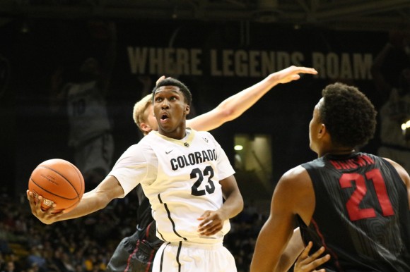 Sophomore Jaron Hopkins lobs the ball toward the basket in the paint, during the second half of play at the Coors Event Center. Hopkins recorded five points against the Cardinals.  (Nigel Amstock/CU Independent)