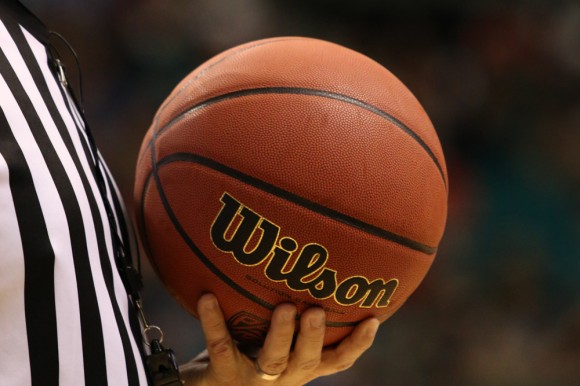 A basketball official holds the game ball during the Pac-12 tournament, one of the 32 conference tournaments that helps funnel teams into the NCAA tournament in March. (Gray Bender/CU Independent)