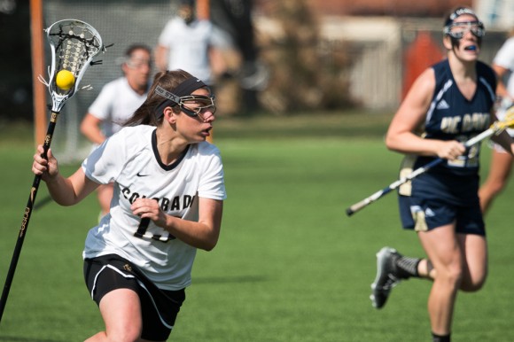 Sophomore attacker Katie Macleay looks for a teammate while bringing the ball upfield. (Matt Sisneros/CU Independent)