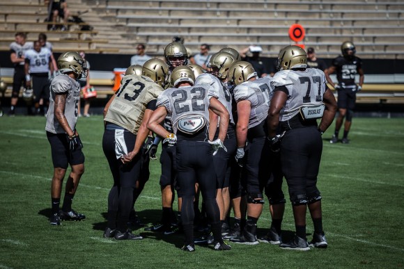 CU's first team offense huddles up during an intrasquad scrimmage on Folsom Field during Fall Camp 2015. (Matt Sisneros/CU Independent)
