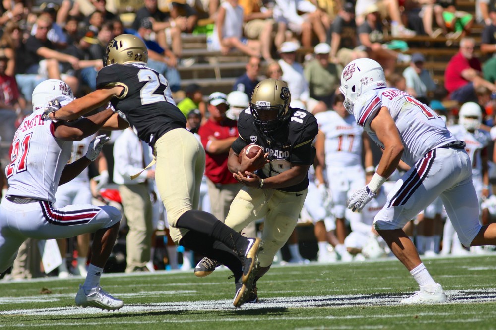 Junior RB Michael Adkins II looks to exploit a gap in the UMass defence during the second quarter of play at Folsom Field. (Nigel Amstock/CU Independent)